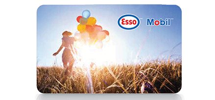 An Esso Mobil gift card shows a woman walking into a sunset while holding a giant bunch of floating balloons.